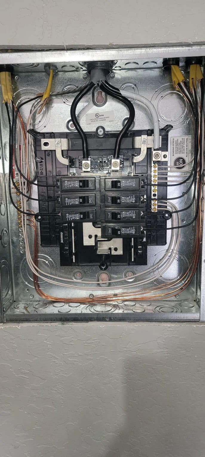 Electrical panel with circuit breakers and wiring, showcasing home electrical system setup.