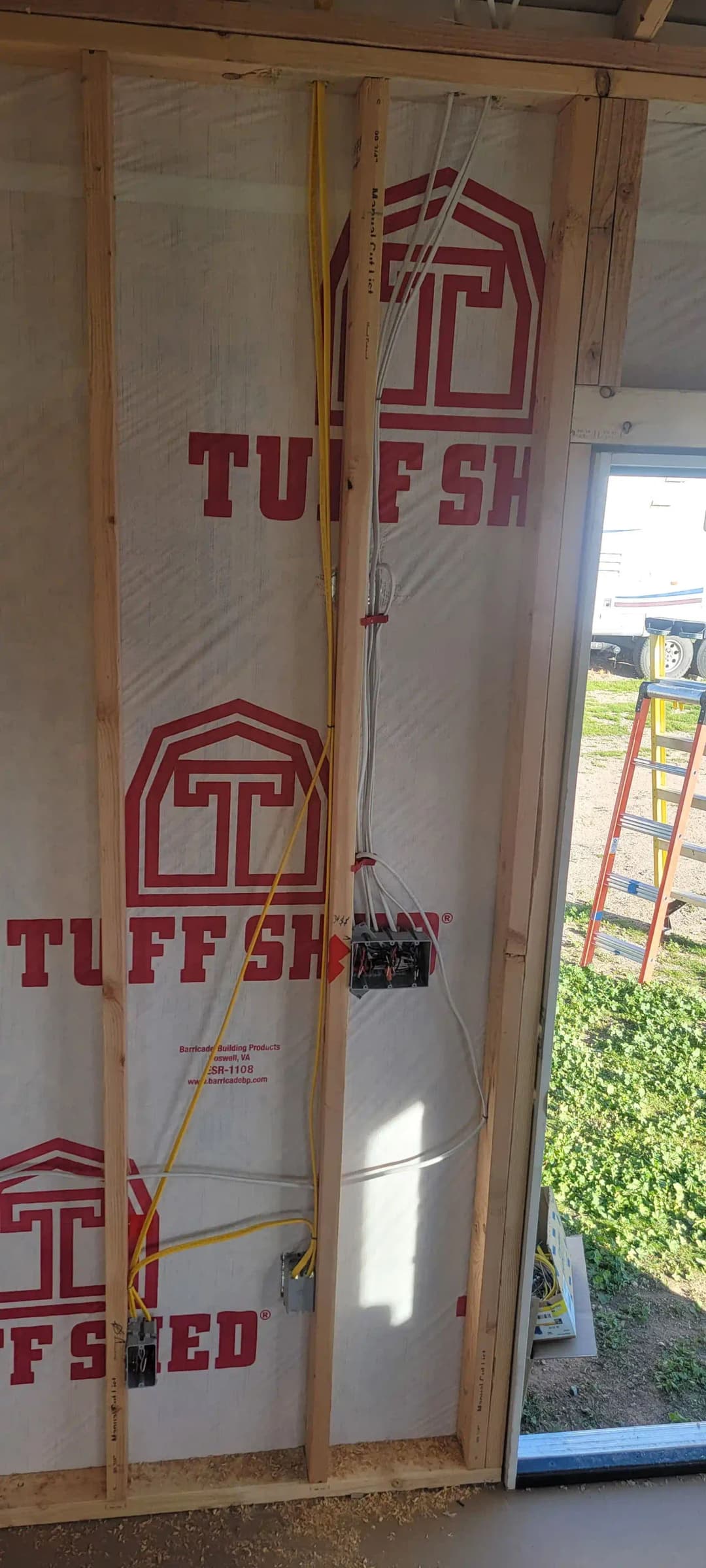 Interior wall featuring TuffSH insulation and electrical wiring during construction phase.